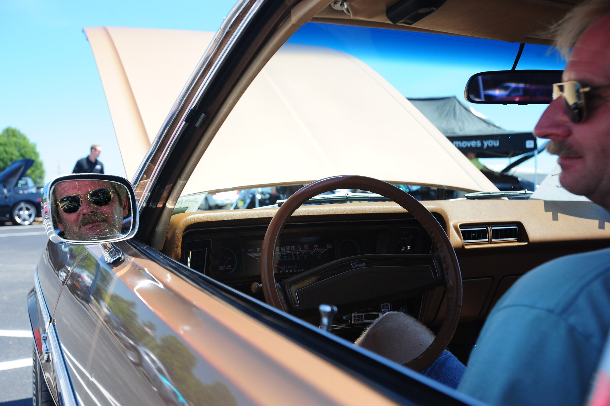 Mr. Patrick Bunting, a 19th Maintenance Squadron aircraft mechanic, relaxes in his 1976 Nova Concourse at the Little Rock Air Force Base Car and Bike Show Friday. Airmen from all across the base came together to view the cars and motorcycles on display in the Hercules Dining Facility Parking lot. (U.S. Air Force photo by Senior Airman Steele Britton)