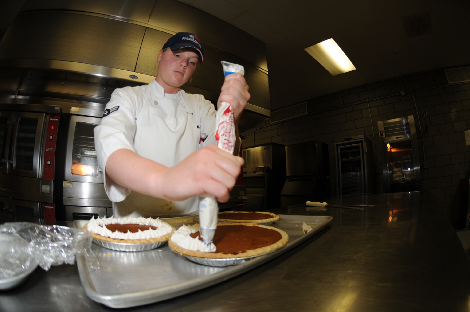 WHITEMAN AIR FORCE BASE, Mo.- Airman 1st Class Holly Kluesner, 509th Force Support Squadron food journeyman, is preparing a pumpkin pie for meal service. Attention to detail in all areas of the Ozark Inn is a driving force behind this award winning facility. (U.S Air Force Photo/ Airman 1st Class Carlin Leslie)