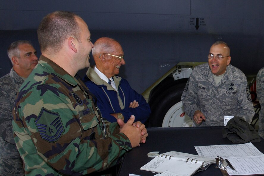 Chief Master Sgt. Mark Clark, 5th Bomb Wing command chief, laughs about a story with Chief Master Sgt. of the Air Force (retired) James M.  McCoy here, Aug 22, 2008.  