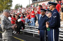 MINOT AIR FORCE BASE, N.D. -- Chief Master Sgt. Mark Clark, 5th Bomb Wing command chief, commends members of Minot Air Force Base Honor Guard for their superb job in presenting the Colors during the Minot State University football game, Oct. 18.  (U.S. Air Force photo by Senior Airman Kelly Timney)