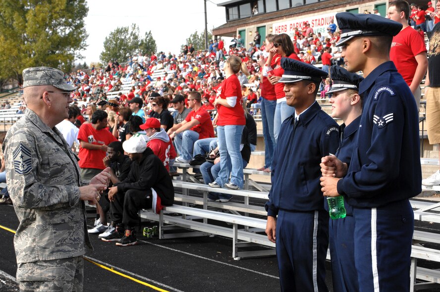 MINOT AIR FORCE BASE, N.D. -- Chief Master Sgt. Mark Clark, 5th Bomb Wing command chief, commends members of Minot Air Force Base Honor Guard for their superb job in presenting the Colors during the Minot State University football game, Oct. 18.  (U.S. Air Force photo by Senior Airman Kelly Timney)