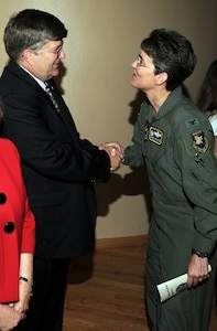 Col. Jacqueline Van Ovost, 12th Flying Training Wing commander, greets new 12th Communications Squadron Commander Gene Boedigheimer during a change of leadership ceremony June 23. Mr. Boedigheimer assumed command of the squadron from Lt. Col. Donald Brown. (U.S. Air Force photo by Steve White)