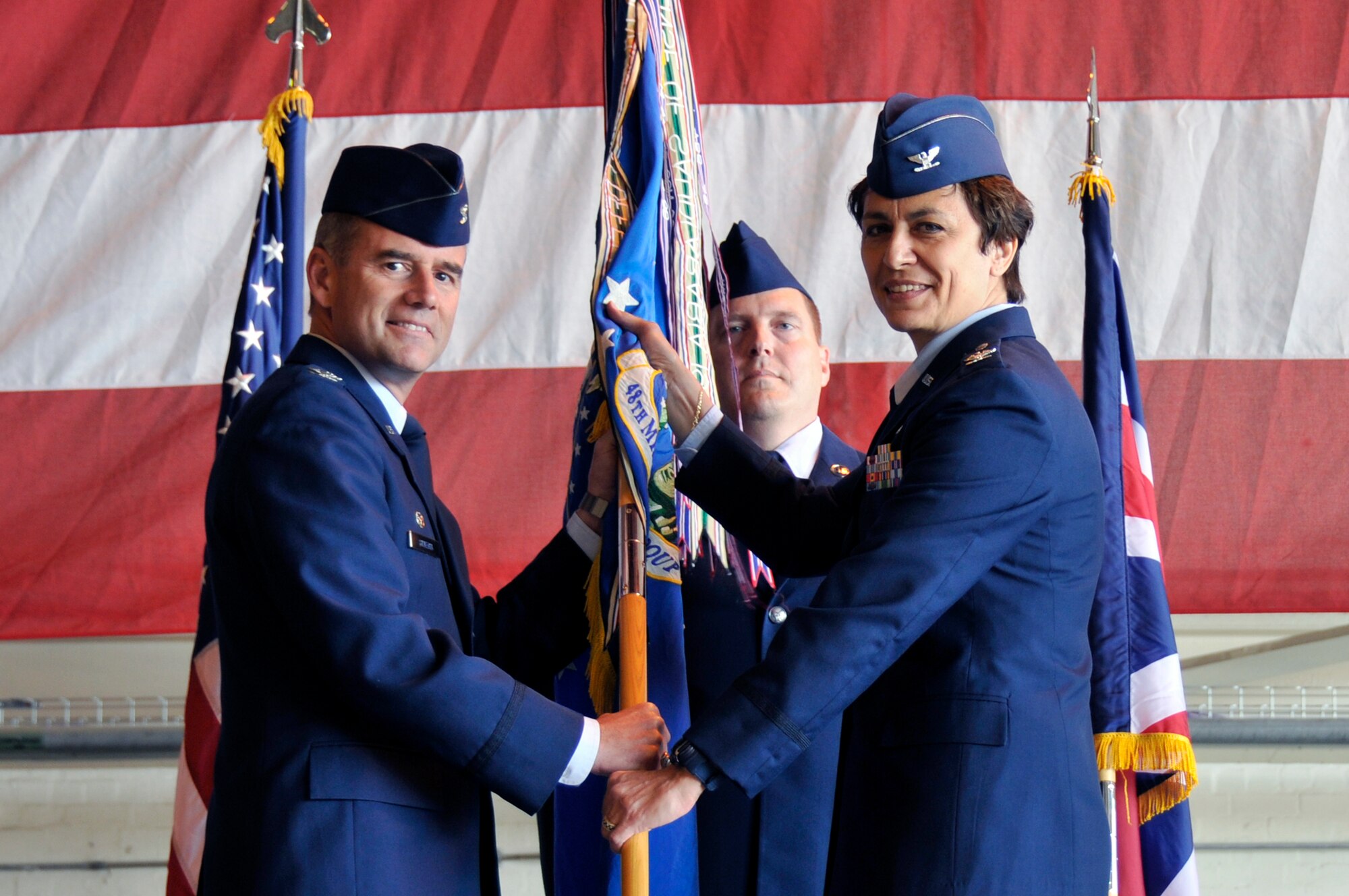 Col. Jay Silveria, 48th Fighter Wing Commander, passes the 48th Mission Support Group guidon to Col. Cassie Barlow as she takes command at RAF Lakenheath, England June 18, 2009. (U.S. Air Force photo by Airman 1st Class Perry Aston) (Released)