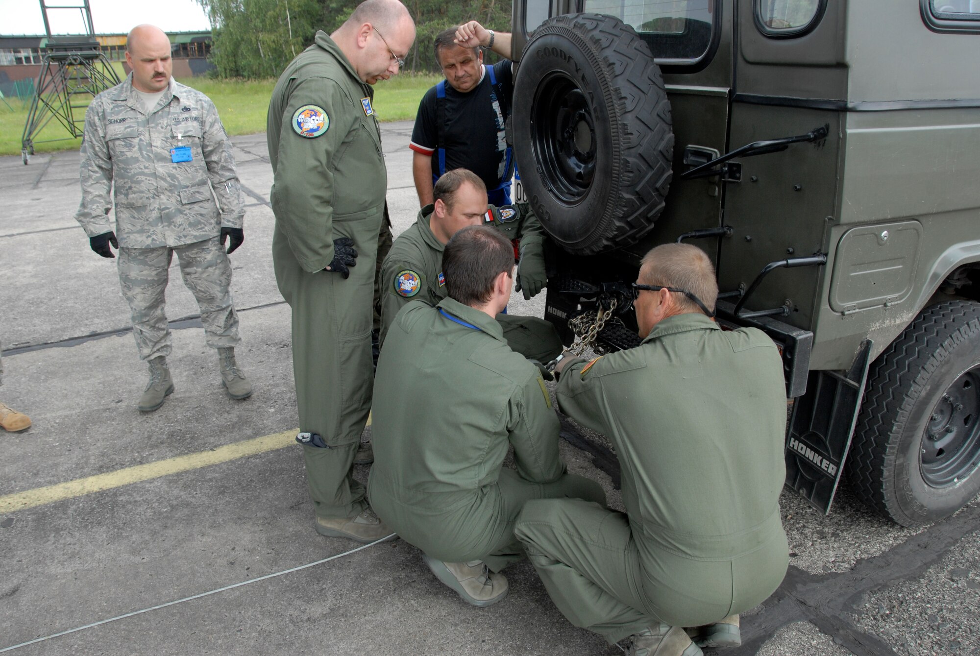 Master Sgt. Shawn Schorr and Tech Sgt.Laurie Waughtel, 182nd Logistics
Readiness Squadron Air Transportation Specialists, observe and assist Polish
Air Force members in loading a Polish 'Honker' all terrain vehicle to a 182
Airlift Wing C-130. The 182nd Airlift Wing is in Poland as part of the
Illinois Air National Guards Partnership with the Polish Air Force under the
State Partnership Program. (U.S. Air Force photo/Tech. Sgt. Shane Hill)