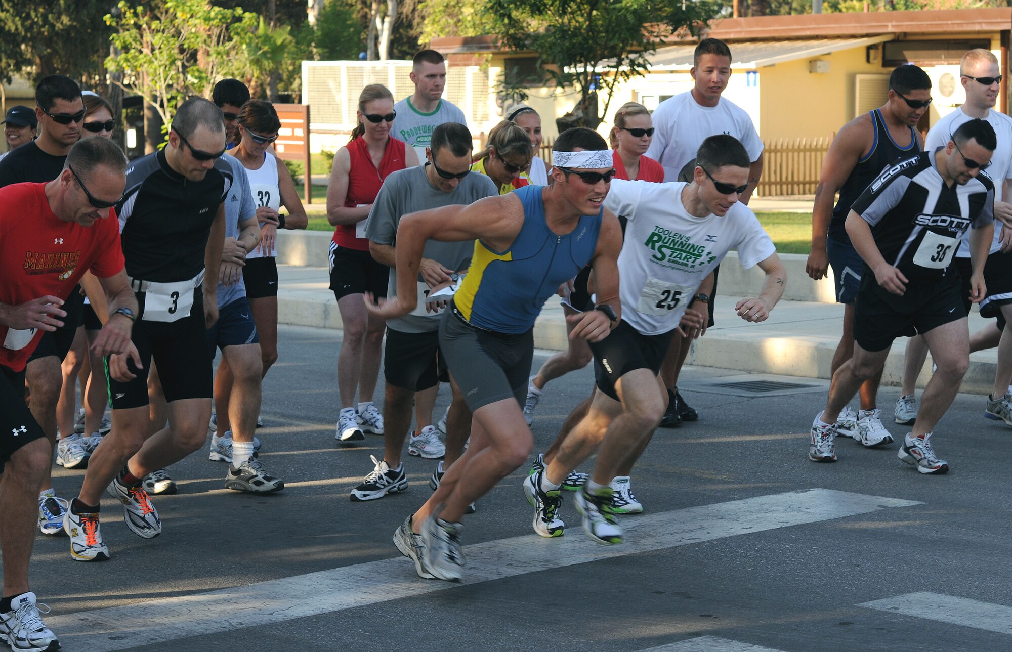 Triathlon participants ignite from the start line of the Sprint Triathlon Saturday, June 20, 2009 at Incirlik Air Base, Turkey. Thirty eight Airmen, civilians and family members participated in the competition. The triathlon added a twist to classic triathlons because the order of events was run, bike and swim instead of the classic swim, bike and run. (U.S. Air Force photo/Senior Airman Alex Martinez)