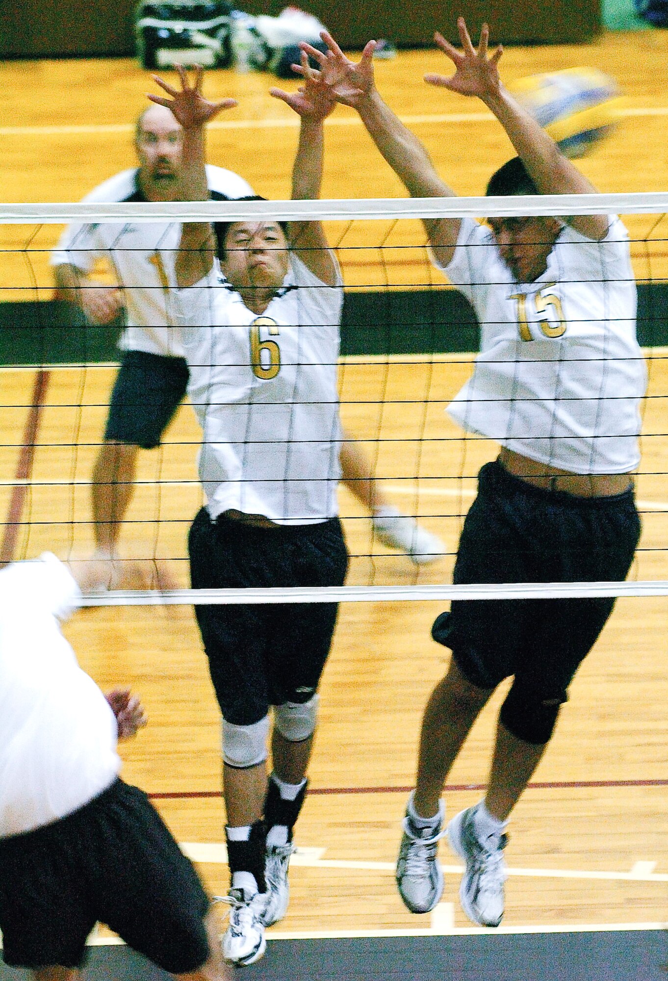 YOKOTA AIR BASE, Japan -- Ryan Wong (No. 6) and James Dela-Pena (No. 15) put up an unsuccessful block against an outside hitter from the Japanese squad Rakkyo June 21 during the championship match of the Kanto Volleyball Invitational Tournament at the Samurai Fitness Center here. The Yokota Warriors won the mens' division of the tournament with a straight-set victory over Rakkyo. The Yokota Warriors womens' team took second, losing in the finale to Link, a local Japanese squad. (U.S. Air Force photo/Master Sgt. Matt Summers)   