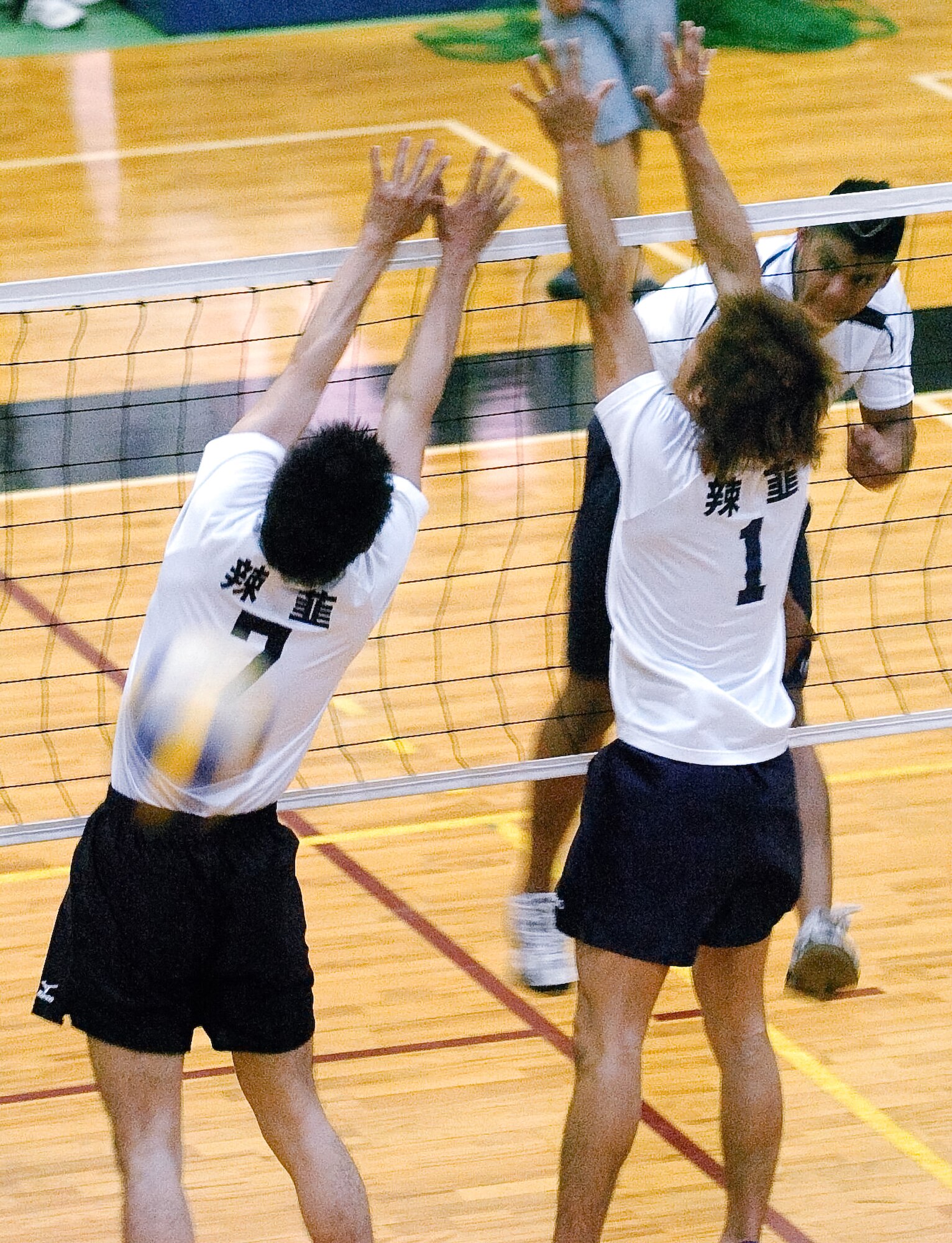 YOKOTA AIR BASE, Japan -- Christopher LaFaurie smokes the ball through a double block set up by the Japanese squad Rakkyo June 21 during the championship match of the Kanto Volleyball Invitational Tournament at the Samurai Fitness Center here. The Yokota Warriors won the mens' division of the tournament with a straight-set victory over Rakkyo. The Yokota Warriors womens' team took second, losing in the finale to Link, a local Japanese squad. (U.S. Air Force photo/Master Sgt. Matt Summers)   
