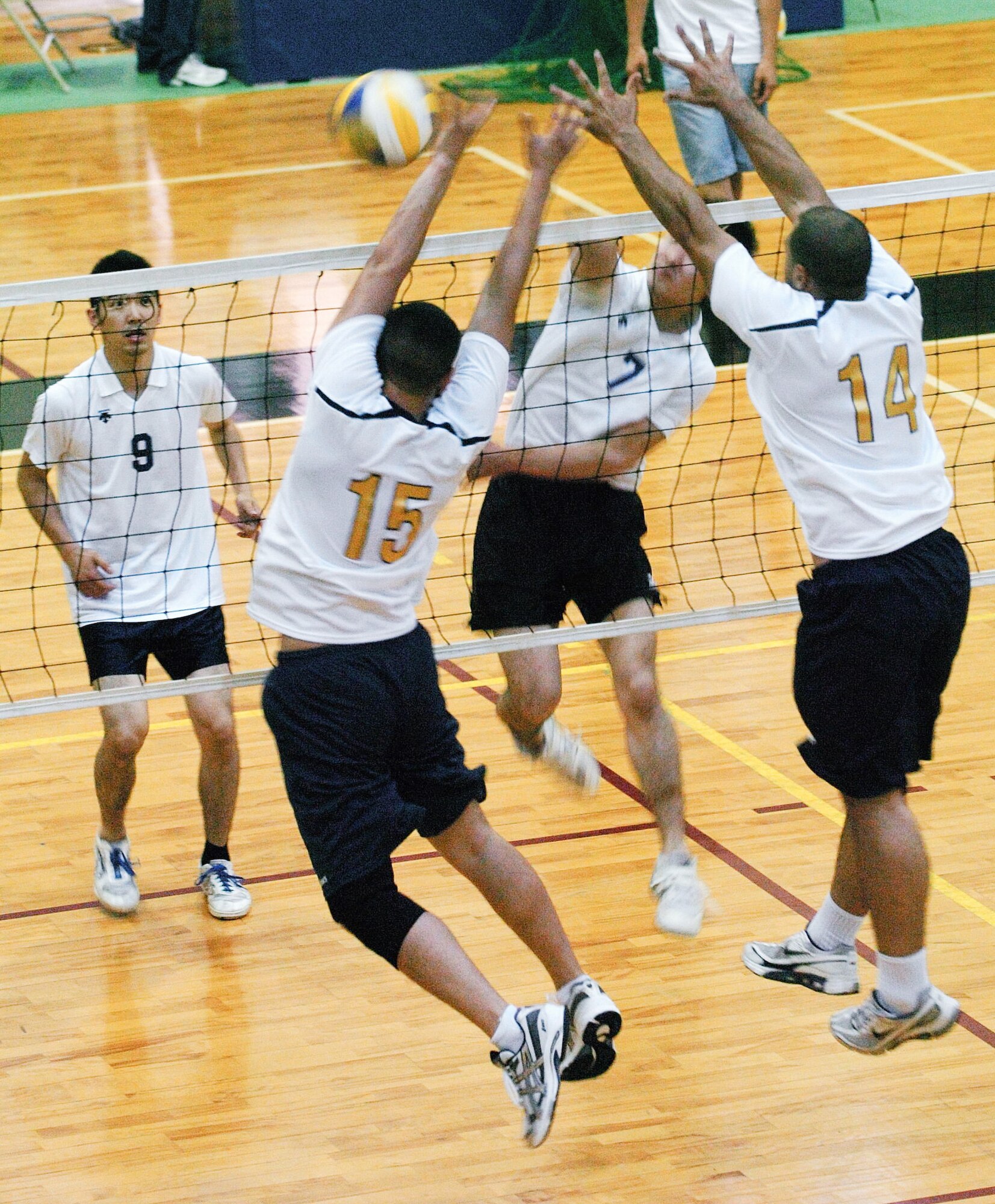 YOKOTA AIR BASE, Japan -- James Dela-Pena (No. 15) and Jonathan Pittman (No. 14) put up an unsuccessful block against an outside hitter from the Japanese squad Rakkyo June 21 during the championship match of the Kanto Volleyball Invitational Tournament at the Samurai Fitness Center here. The Yokota Warriors won the mens' division of the tournament with a straight-set victory over Rakkyo. The Yokota Warriors womens' team took second, losing in the final to Link, a local Japanese squad. (U.S. Air Force photo/Master Sgt. Matt Summers)   