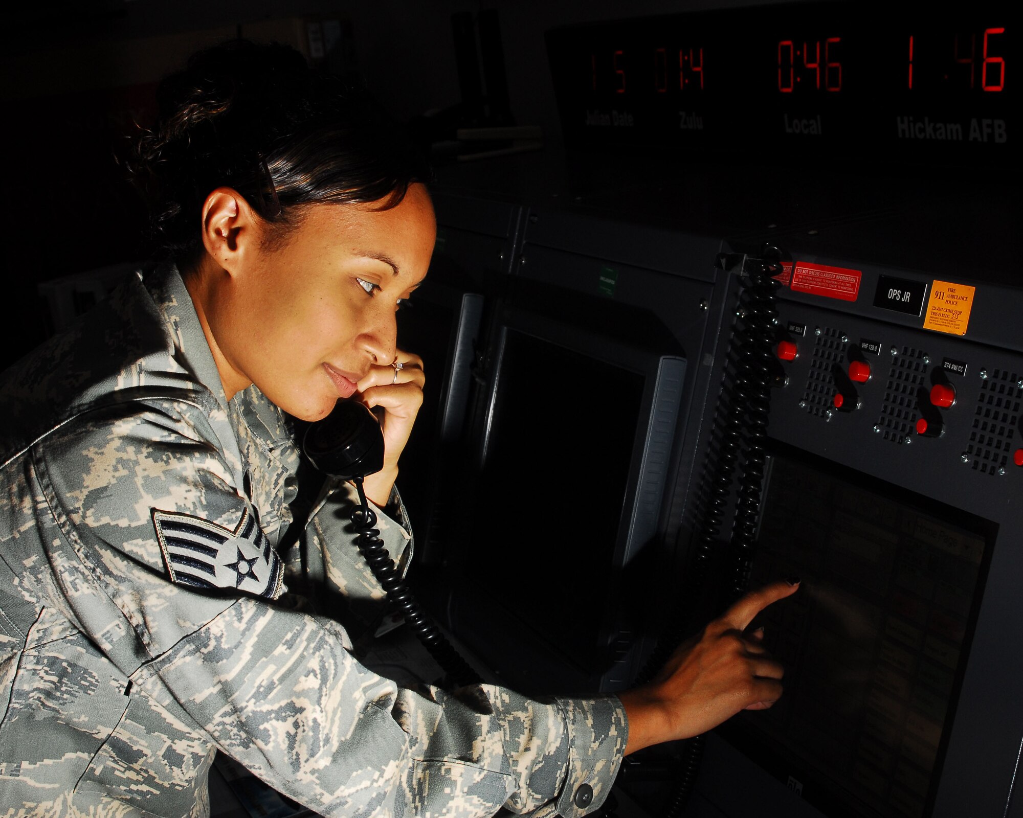 YOKOTA AIR BASE, Japan -- Staff Sgt. Sharon Santayana, 374th Airlift Wing Command Post emergency actions controller, transfers a call. The command post receives and relays command and control instructions and records, and submits manual and automated data projects. (U.S. Air Force photo/Airman 1st Class Sean Martin)