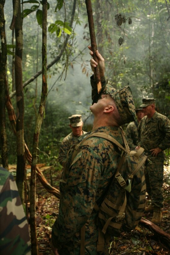 U.S. Marine Col. Jay Huston, the commanding officer of 24th Marine Regiment, drinks fresh water from a jungle vine June 25, 2010 while visiting Marines on deployment with Landing Force Cooperation Afloat Readiness and Training in Malaysia.  Several reserve officers had the opportunity to lead more than two hundred reservists from the 24th Marine Regiment during the entire four-month exercise.