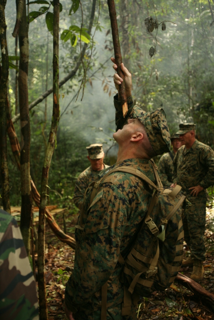 U.S. Marine Col. Jay Huston, the commanding officer of 24th Marine Regiment, drinks fresh water from a jungle vine June 25, 2009 while visiting Marines on deployment with Landing Force Cooperation Afloat Readiness and Training in Malaysia. CARAT is an annual series of bi-lateral maritime training exercises between the United States and Southeast Asian nations. Several reserve officers had the opportunity to lead more than two hundred reservists from the 24th Marine Regiment during the entire four-month exercise on temporary mobilization orders. Official Marine Corps photo by