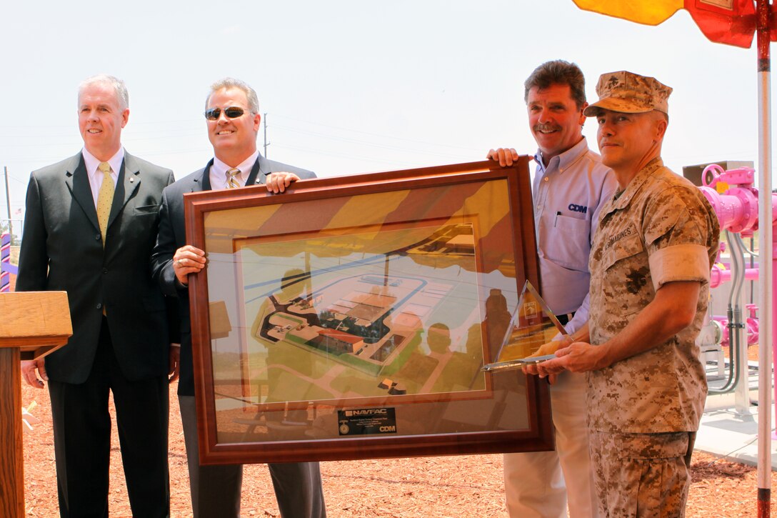 (From left to right) Representatives from CDM Constructors Inc, Michael C. Malloy, Mike Dzubnar and Mark R. Andrews stand next to Col. Gary W. Storey, Assistant Chief of Staff Facilities, Camp Pendleton during a ribbon-cutting ceremony of the new P-110 Recycled Water Plant in Camp Pendleton, June 24. The completion of P-110 will allow Camp Pendleton to develop an extensive system to irrigate green spaces in several areas in the southern region of the base.