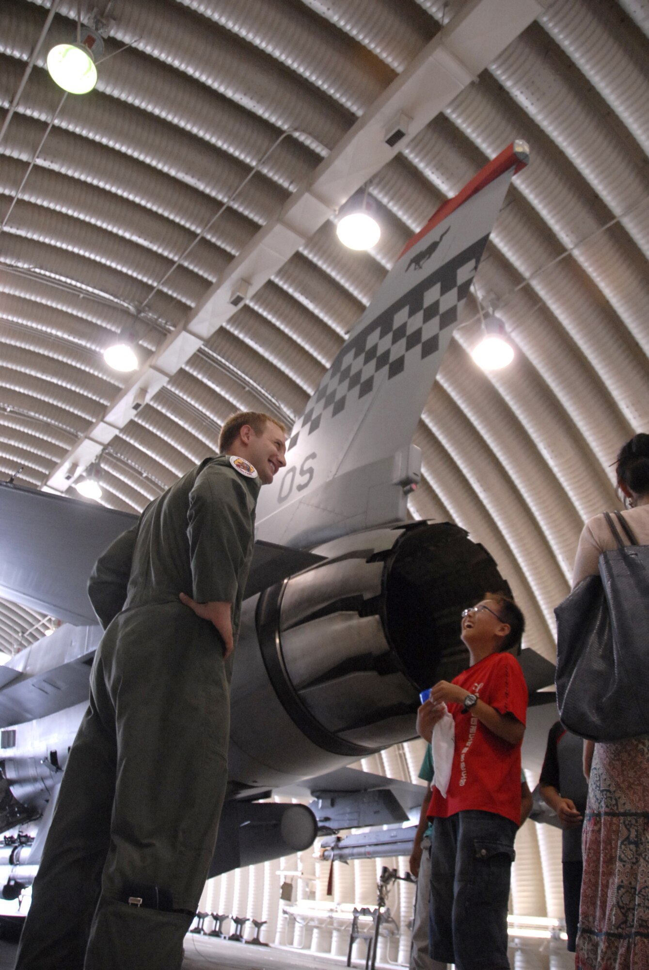 Capt. Kristopher Holstege explains to student s from the Seojenongri Elementary School how the rear wings of the F-16 aircraft assist the pilot while flying during the students visit to Osan AB June. 19. Airmen from the 51st Dental Squadron and Operations Group here joined together to Adopt-A-School for a day and gave them a tour of the base and flightline. Captain Holstege is a member of the 36th Fighter Squadron. (U.S. Air Force photo/Master Sgt. Marlin Zimmerman)