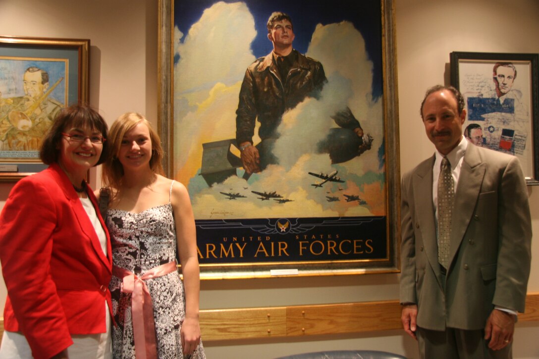 A historic moment in time reuniting the families of Jes Schlaikjer (the artist who painted "O'er the Ramparts We Watch") and Army Air Forces Captain Thomas Wakeman Jr. (the WW II pilot depicted in the painting).  This was taken 21 June 2007 at The USAF Band, Historic Hangar II, Conference Room.  Pictured from left to right are Carol Ready (the daughter of Captain Thomas Wakeman, Jr.), her daughter, and Paul Biegel (the grandson of artist Jes Schlaikjer).
