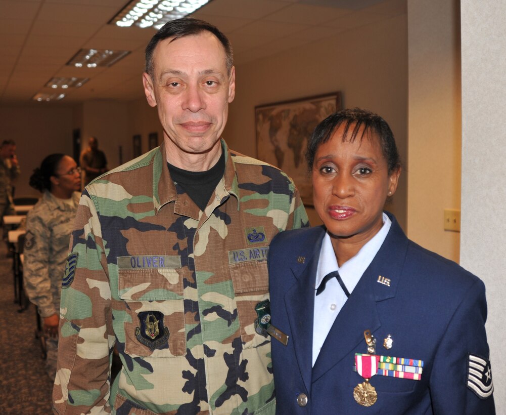 Tech. Sgt. Dan Oliver says his final farewell to Tech. Sgt. Adriane Palmer who retired from the 932nd Airlift Wing.  She was known for helping with family readiness and her pride in the American flag, while calling out marching cadence and songs during community parades.  (U.S. Air Force photo/Maj. Stan Paregien)
