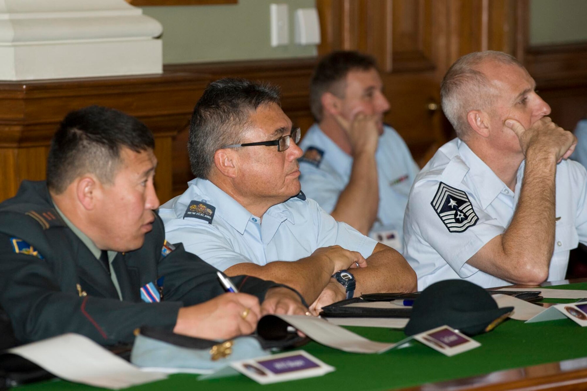 Warrant Officer Keith Gell, Royal New Zealand Air Force warrant officer of the air force (center), and Chief Master Sgt. Harry Viel, 7th Air Force command chief master sergeant at Osan Air Base, South Korea (right), listen to a presentation during the Senior Enlisted Leadership Conference in Wellington, New Zealand, June 24.  The conference, co-hosted by the RNZAF and U.S. Air Force, gathered senior enlisted leaders from air forces throughout the Asia-Pacific region June 23-27. (New Zealand Defence Force photo/LAC Rachael Park)
