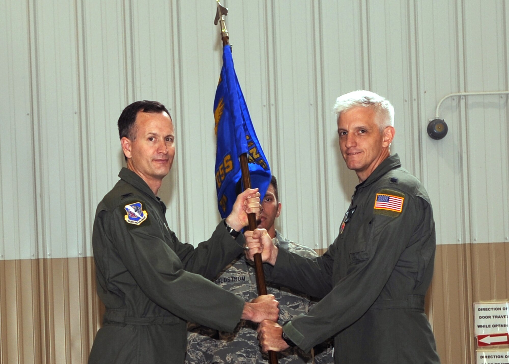 Lt. Col. John Lussier receives the 563rd Operations Support Squadron guidon from Col. Billy Thompson, 563rd Rescue Group commander, during the change-of-command ceremony here June 19. Colonel Lussier assumed command of the 563rd OSS from Lt. Col. Denis Doty. (U.S. Air Force photo/Master Sgt. Heather Cabral) 