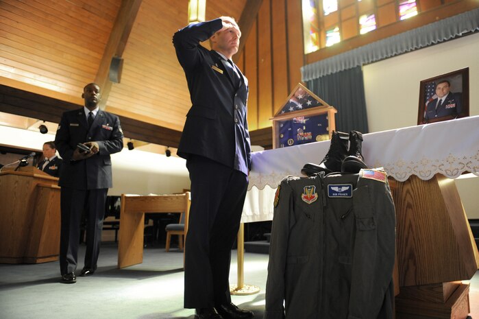 Col. Christian Benjamin, 99th Medical Group commander, pays his final respects to Lt. Col. H. Robert Prager, before awarding him the Meritorious Service Medal during a special memorial ceremony honoring Lt. Col. Prager at the base chapel, Nellis Air Force Base, Nev., June 23. Lt. Col. Prager was a flight surgeon assigned to the 99th Medical Group and was laid to rest with full military honors.(U.S. Air Force Photo/Senior Airman Larry E. Reid Jr.)