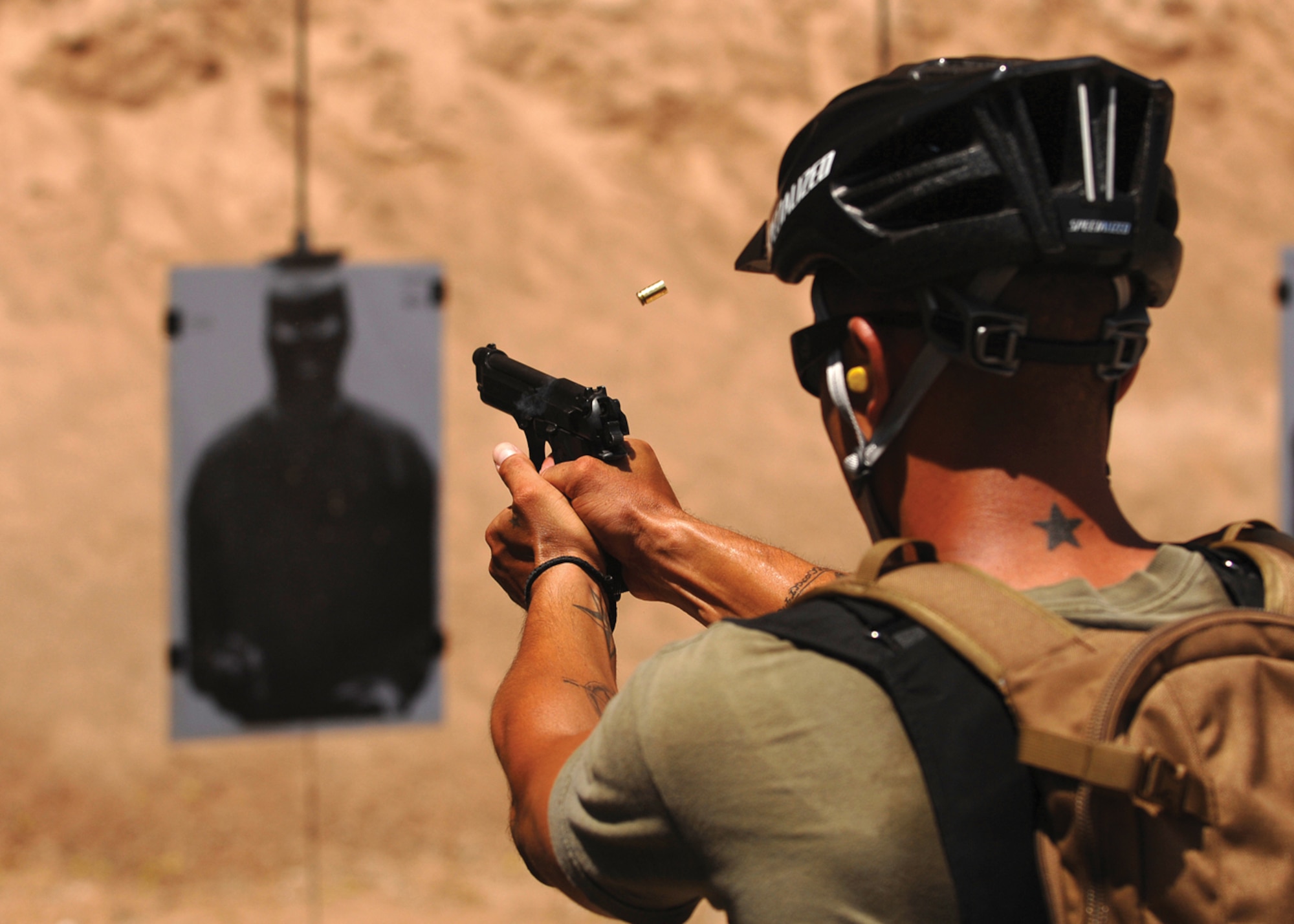 Officer William Monjaras, 56th Security Forces Squadron Defense Department police, fires on a target at the Glendale Training Center Range. (U.S. Air Force photo/ Tech. Sgt. Jeffery Wolfe)