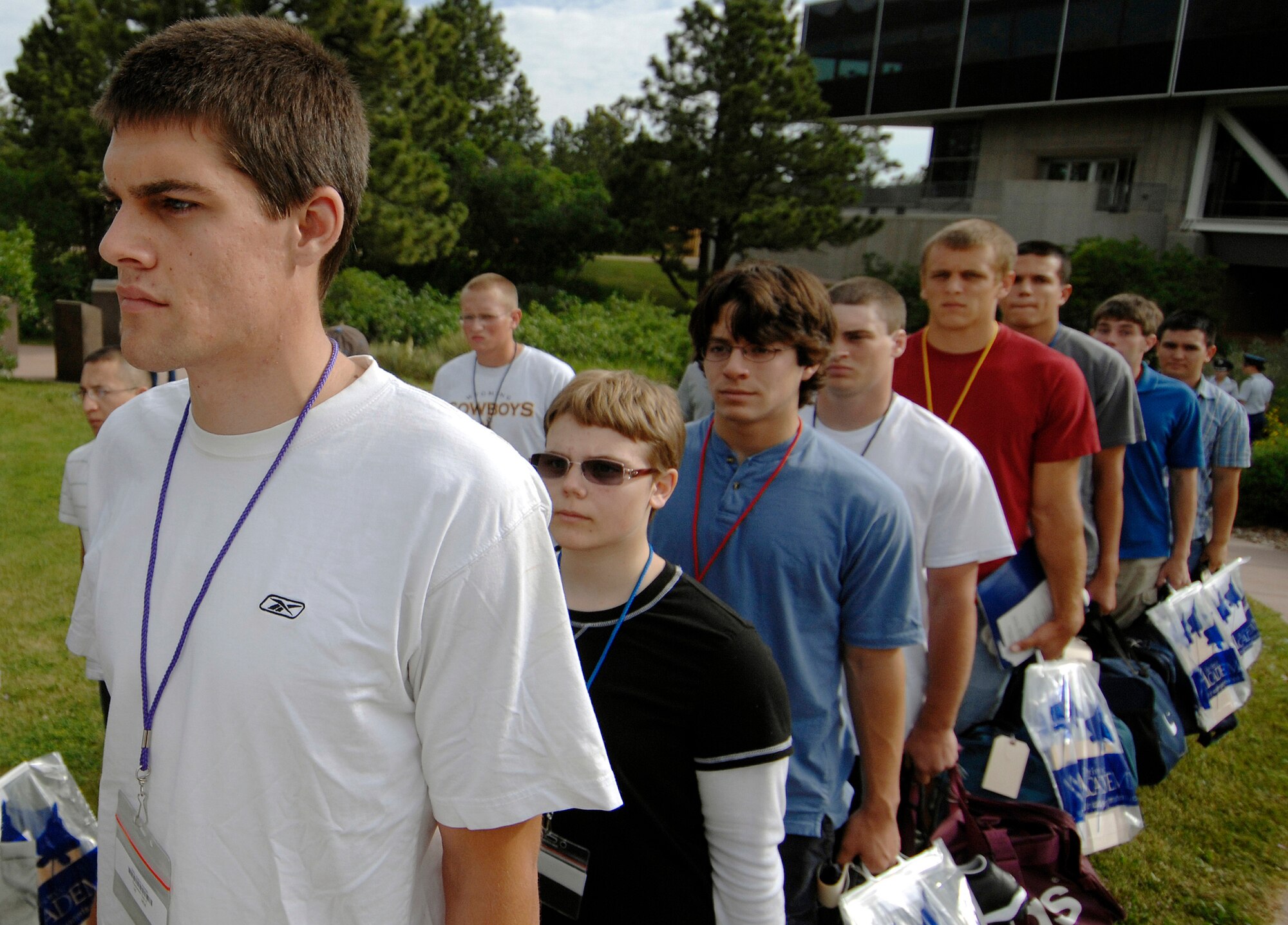 Basic cadets wait to board a bus from the Association of Graduates' Heritage Trail to the cadet area during cadet inprocessing at the U.S. Air Force Academy in Colorado Springs, Colo., June 25. Of the more than 1,300 cadets accepted into the Class of 2013, 41 are prior enlisted servicemembers, and 31 graduated from the Academy's Preparatory School. (U.S. Air Force photo/Dennis Rogers)