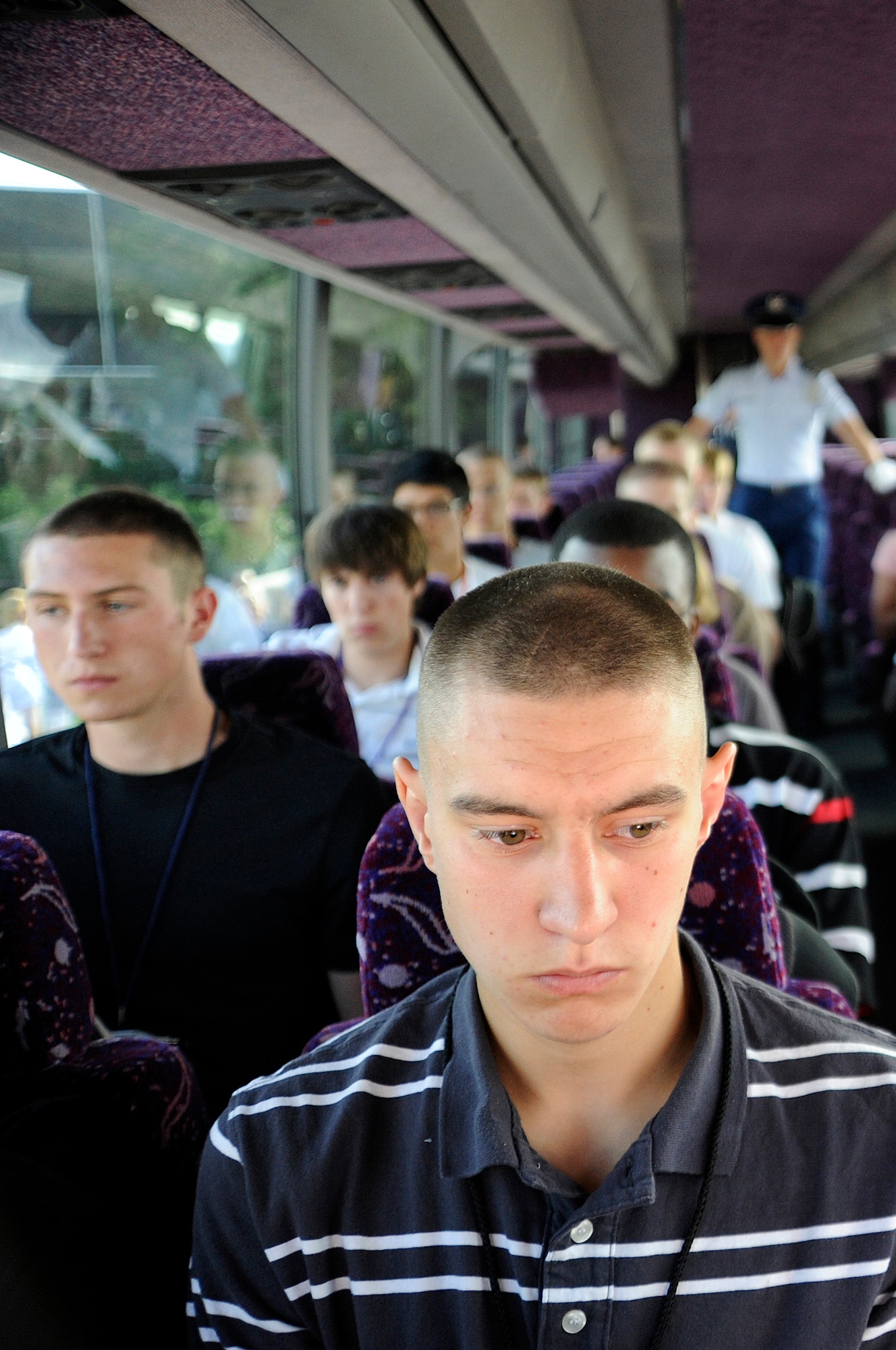 Basic cadets ride in a bus from Doolittle Hall to the cadet area at the U.S. Air Force Academy during cadet inprocessing at the U.S. Air Force Academy in Colorado Springs, Colo., June 25. More than 1,300 cadets were accepted to the Class of 2013 out of nearly 10,000 applicants. (U.S. Air Force photo/Mike Kaplan)