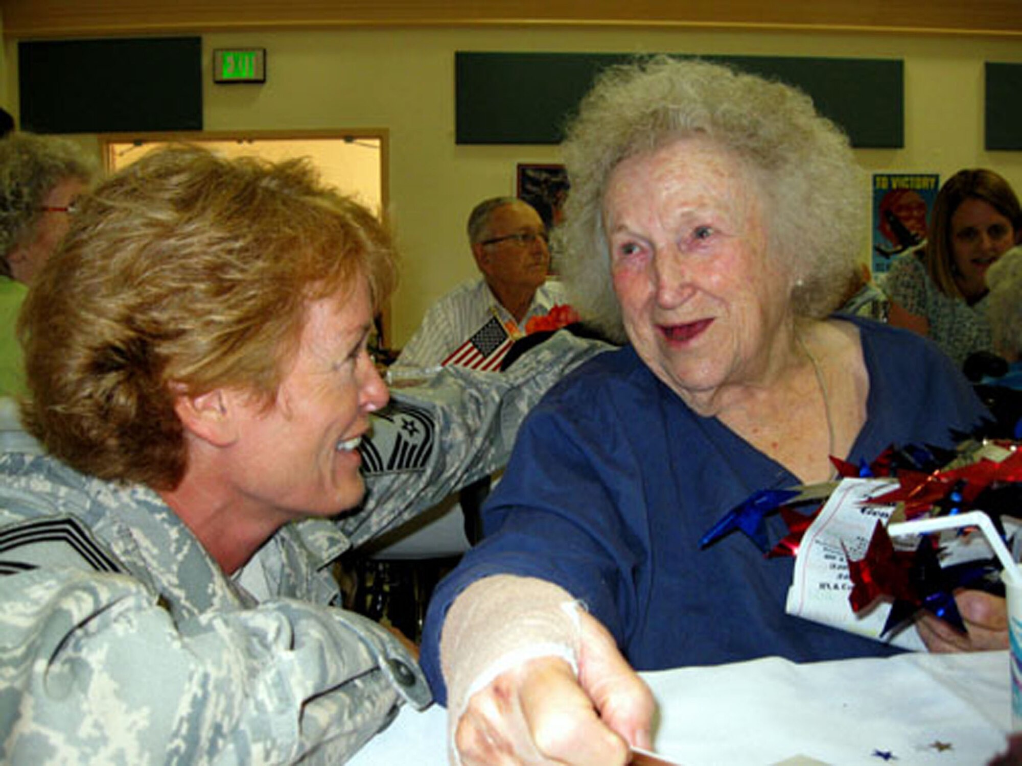 TRAVIS AIR FORCE BASE, Calif. -- Chief Master Sgt. Karen Krause wishes a resident of the California Veterans Home, Yountville, a happy 92nd birthday June 20, 2009. The Chief joined a large group of reservists from the 349th Air Mobility Wing who visit the veterans yearly during Operation Gratitude. The Air Force reservists set up and serve a champagne brunch to the veterans as their way of saying "Thank you for your service to America." Read the full story in the August issue of the Contact magazine. (U.S. Air Force photo/Senior Master Sgt. Ellen Hatfield)