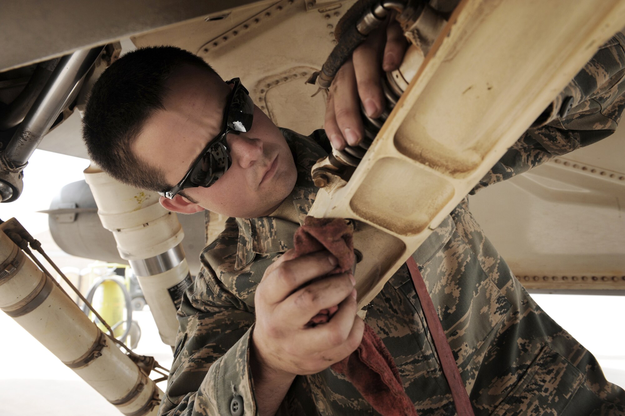 Airman 1st Class Jay Costner performs a pre-flight inspection on an F-16 Fighting Falcon June 19 at Joint Base Balad, Iraq. During the inspection, he looks for any cracks and obvious damage on the aircraft. Airman Costner is an F-16 crew chief with the 332nd Expeditionary Aircraft Maintenance Squadron, and deployed from Spangdahlem Air Base, Germany.  (U.S. Air Force photo/Senior Airman Elizabeth Rissmiller)