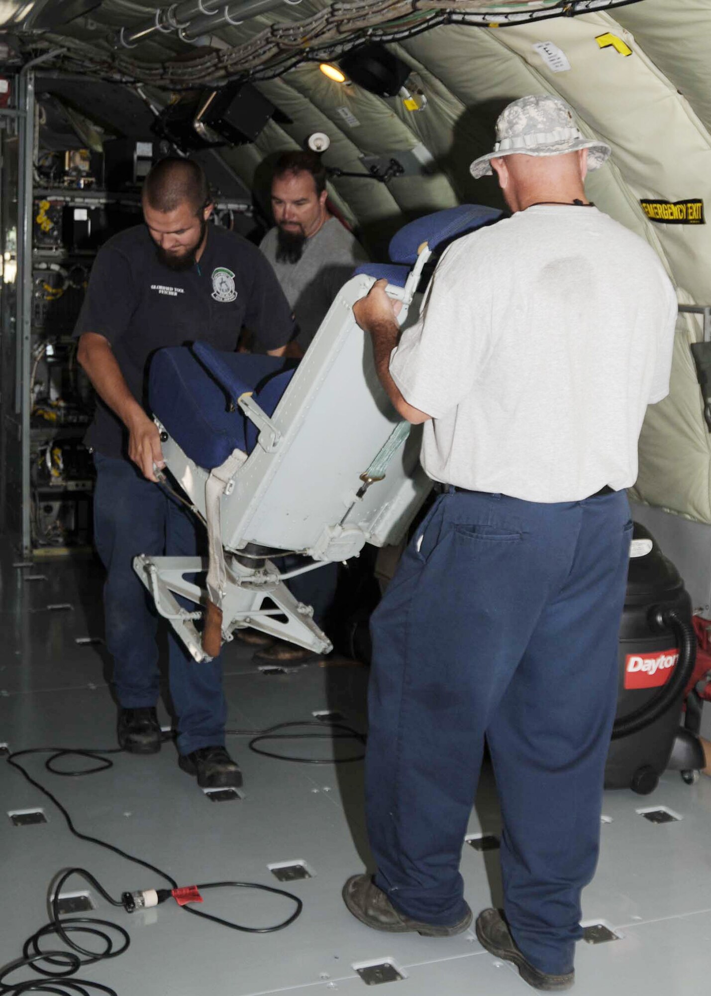 Members of the 97th Maintenance Directorate move chairs from the cockpit of a KC-135 Stratotanker to install carpeting on the floor of the aircraft. The maintainers are preparing for the 2009 Air Mobility Command Rodeo at McChord Air Force Base, Wash., in July. (U.S. Air Force photo/Airman 1st Class Tiffany M. Deuel) 
