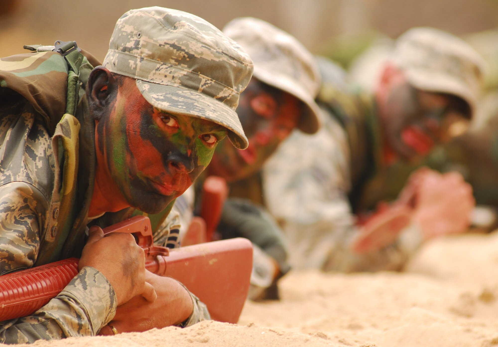 VANDENBERG AIR FORCE BASE, Calif. -- Crawling into the sand, members of Team Vandenberg simulate an enemy attack during a North Star exercise June 24 at Cocheo Park here. North Star’s overall objective is to provide tasked personnel similar pre-deployment training normally received before supporting a deployment tasking. (U.S. Air Force photo/Airman 1st Class Kerelin Molina)