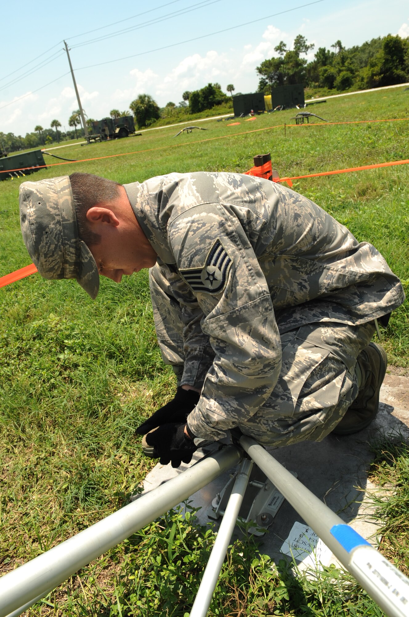 Staff Sgt. Benjamin Kuhl, network infrastructure technician from the 27th Special Operations Communications Squadron, tightens screws on a satellite during the joint lightning DV/demo tour June 15.  The Communications Exercise (COMMEX) Joint Lightning 2009 lasted from June 7-21 with participants from varying locations.  (U.S. Air Force photographer Senior Airman Nancy Hooks)
