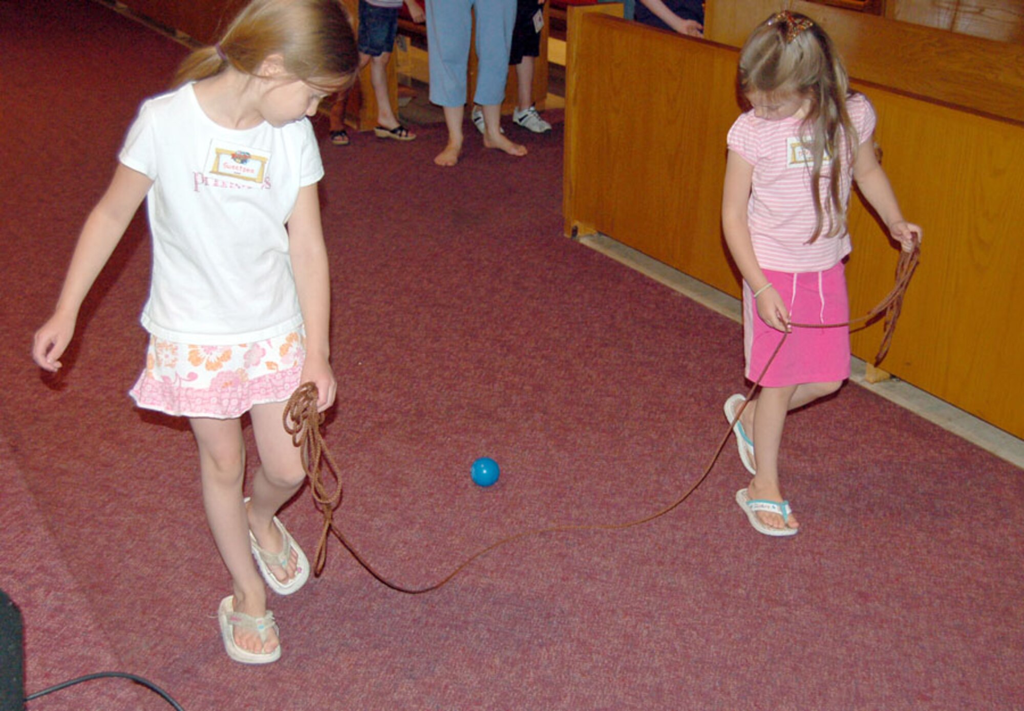 Seven-year-old Sweetpea Limbough and her six-year-old sister Tiffany participated in moving a ball together during Vacation Bible School, Truth Trek: Digging up God’s Treasures activities at the Peterson Air Force Base Chapel June 17. The Limbough girls participated in the five-day vacation school that held a theme for each day. The June 17 theme was “Show my Love for God by Loving my Parents.” (U.S. Air Force photo by Thea Skinner)