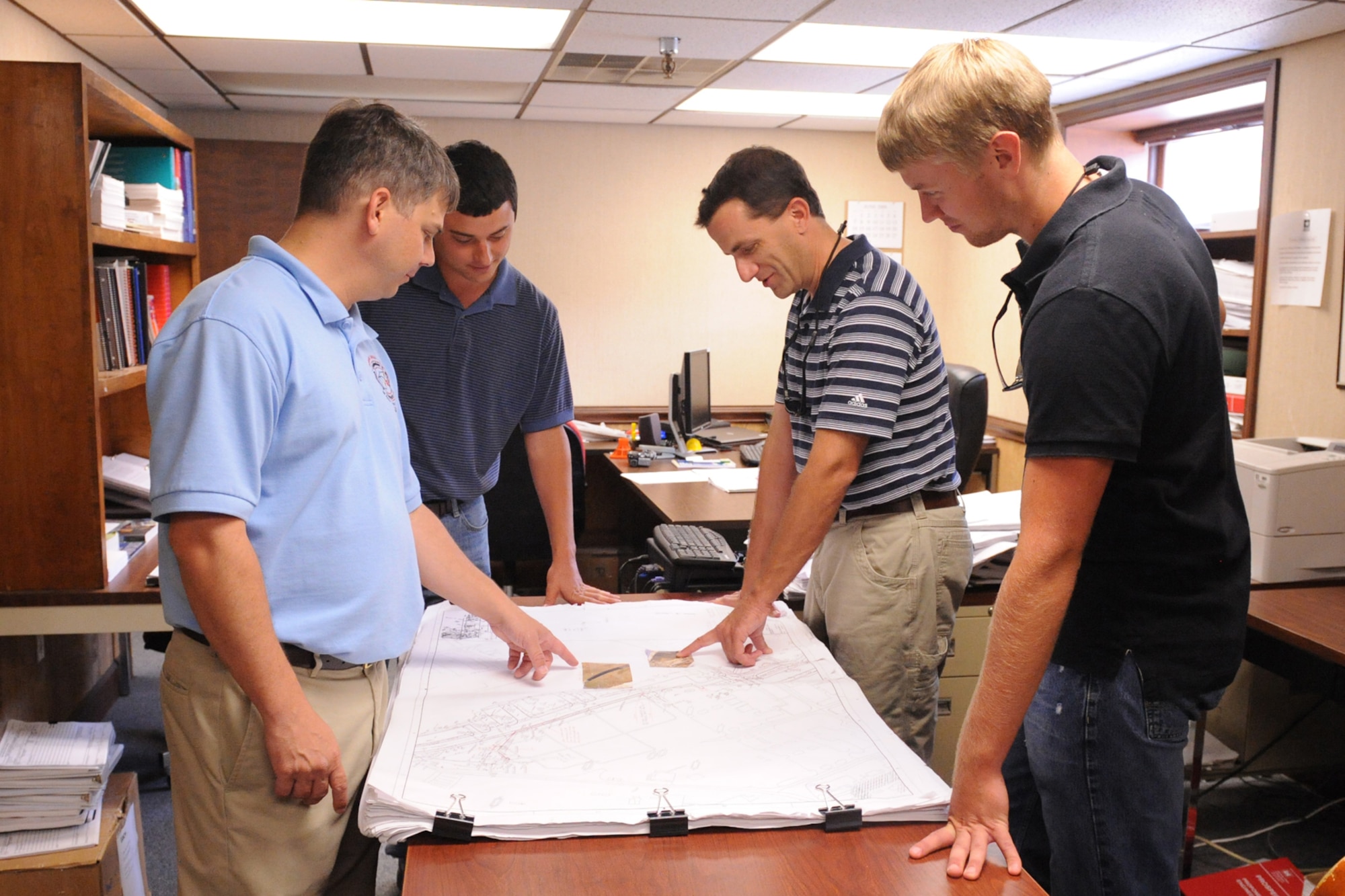 U.S. Army Corps of Engineers employees discuss details of an upcoming project at the 4th Civil Engineer Squadron on Seymour Johnson Air Force Base, N.C., June 24, 2009. In 1940, the Secretary of Defense assigned all construction on bases bordering the Atlantic Ocean to the U.S. Army Corps of Engineers. (U.S. Air Force photo by Airman 1st Class Whitney S. Lambert)