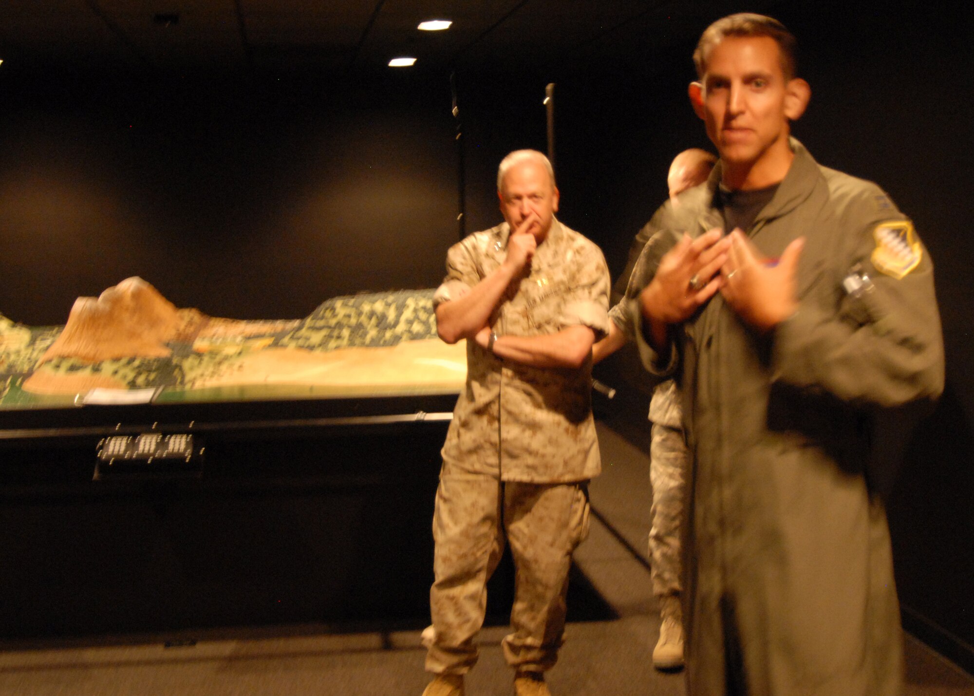 Marine Maj. Gen. John Croley, 4th Marine Aircraft Wing commander looks on as Capt. Jeffery Scott, Edwards aerospace physiologist, talks about the capabilities of the Night Imaging and Threat Evaluation Laboratory. The NITE Lab will offer a hands-on training course for all pilots required to use night vision goggles. (Air Force photo/Airman 1st Class William O'Brien)