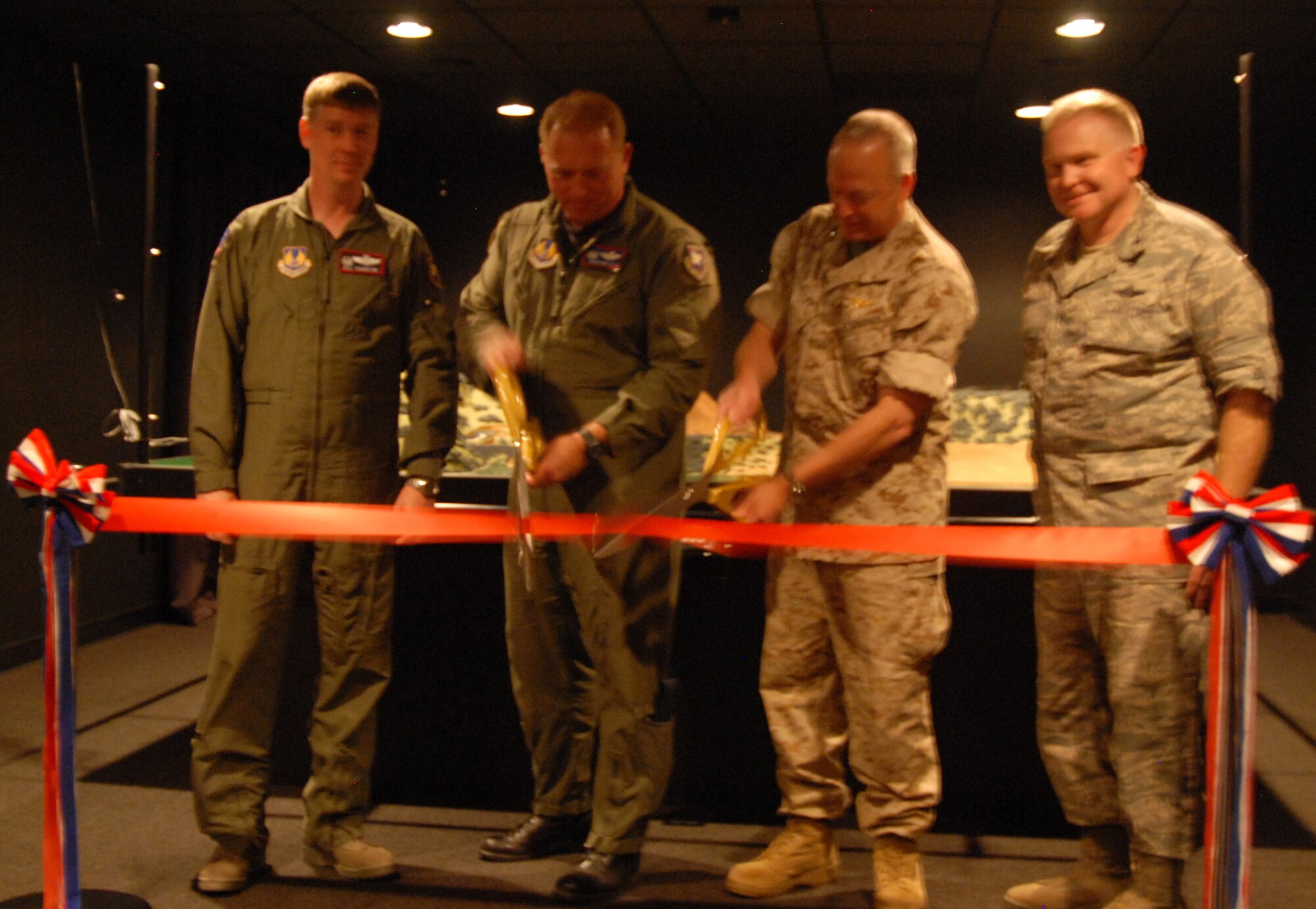 Marine Maj. Gen. John Croley (second from right), 4th Marine Aircraft Wing commander and Col. David Miller, Air Force Flight Test Center vice commander, cut the ribbon to mark the opening of the Night Imaging and Threat Evaluation Laboratory June 18, as Col. William Thornton (left), 412th Test Wing commander and Col. Jerry Gandy (right), 95th Air Base Wing commander, look on. The $129,000 NITE Lab was a joint effort between the Air Force and Marine Corps. (Air Force photo/Airman 1st Class William O'Brien)