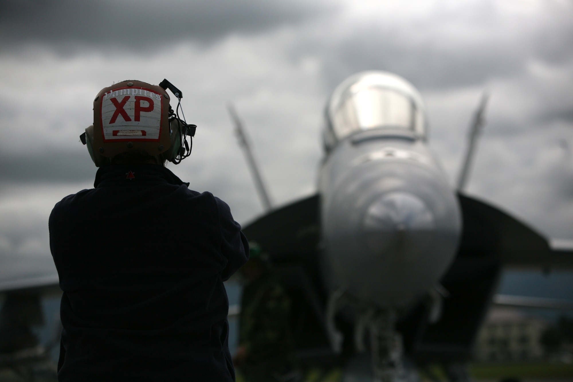 ELMENDORF AIR FORCE BASE, Alaska -- Deanna Word, a civilian plane captain with Navy Air Test and Evaluation Squadron 9, looks on as an F/A-18F Super Hornet powers up on the flightline here June 19. (U.S. Air Force photo/Marine Corps Sgt. Zachary Dyer)
