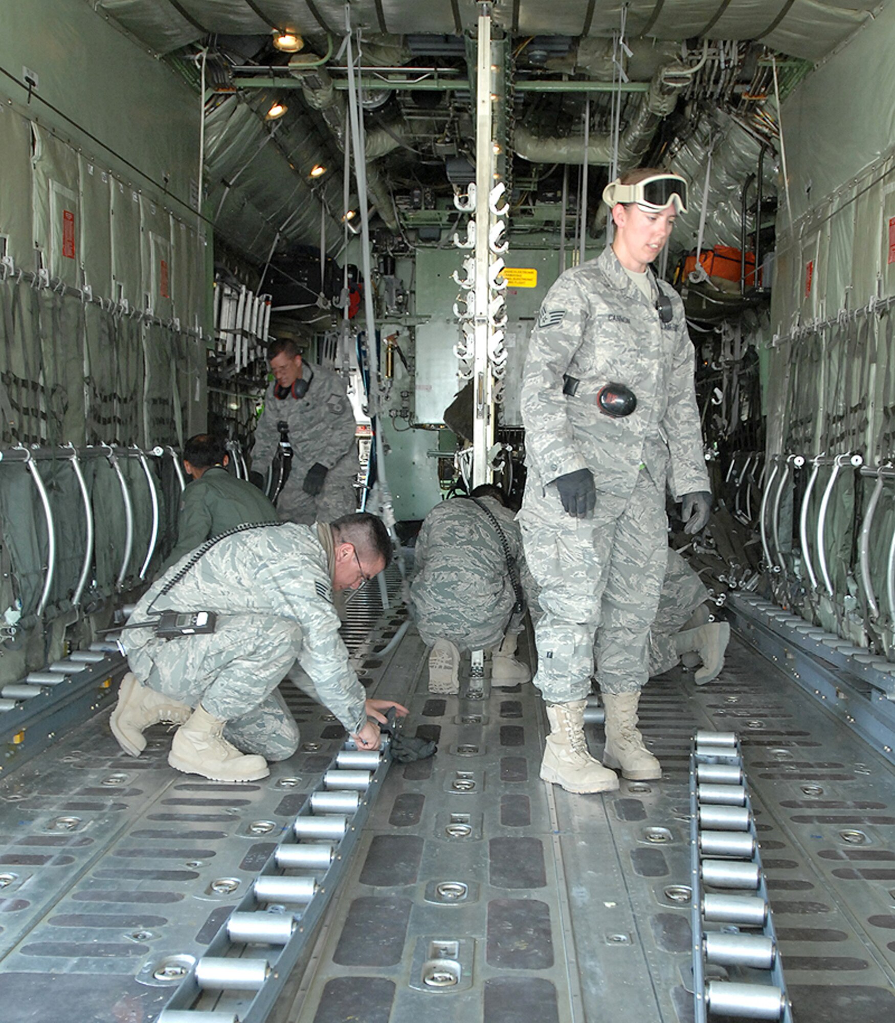 Airmen from the 506th Expeditionary Logistics Readiness Squadron assist a Turkish air force C-130 aircrew prepare the aircraft for patient transport June 22 at Kirkuk Air Base, Iraq. U.S. and Turkish airmen, U.S. State Department officials at the Kirkuk Provincial Reconstruction Team, and Turkish Red Crescent Society medical responders helped coordinate and facilitate an aeromedical evacuation for 11 victims of a June 20 suicide truck bombing in Taza District south of Kirkuk city. More than 80 people were killed and 250 injured in the blast. (U.S. Air Force photo/Staff Sgt. Eunique Stevens) 