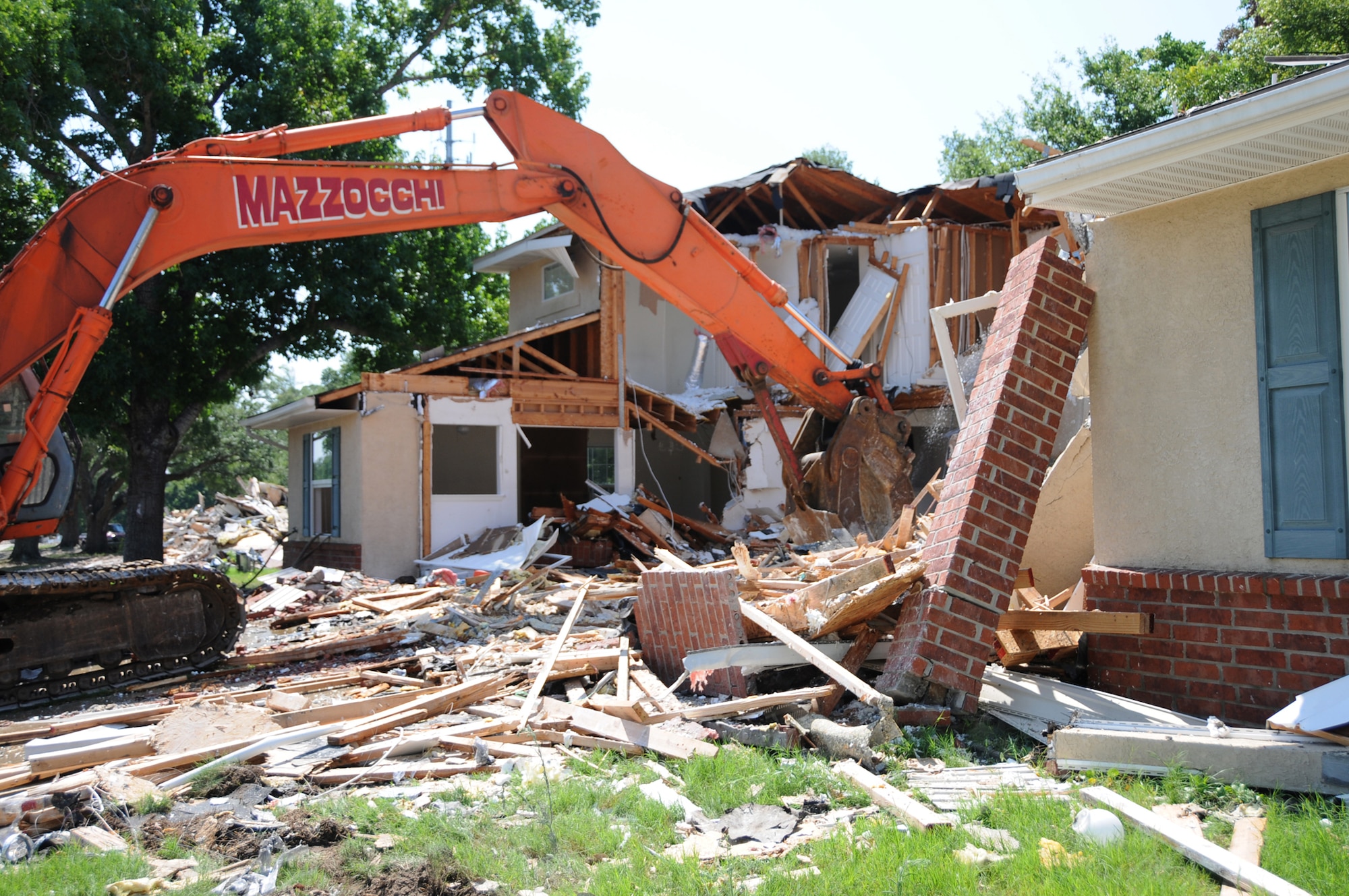 Demolition of the homes in South Pinehaven should be finished by mid-September.  Motorists are asked to exercise extreme caution with the increased volume of heavy equipment traffic in the area.  (U.S. Air Force photo by Kemberly Groue)