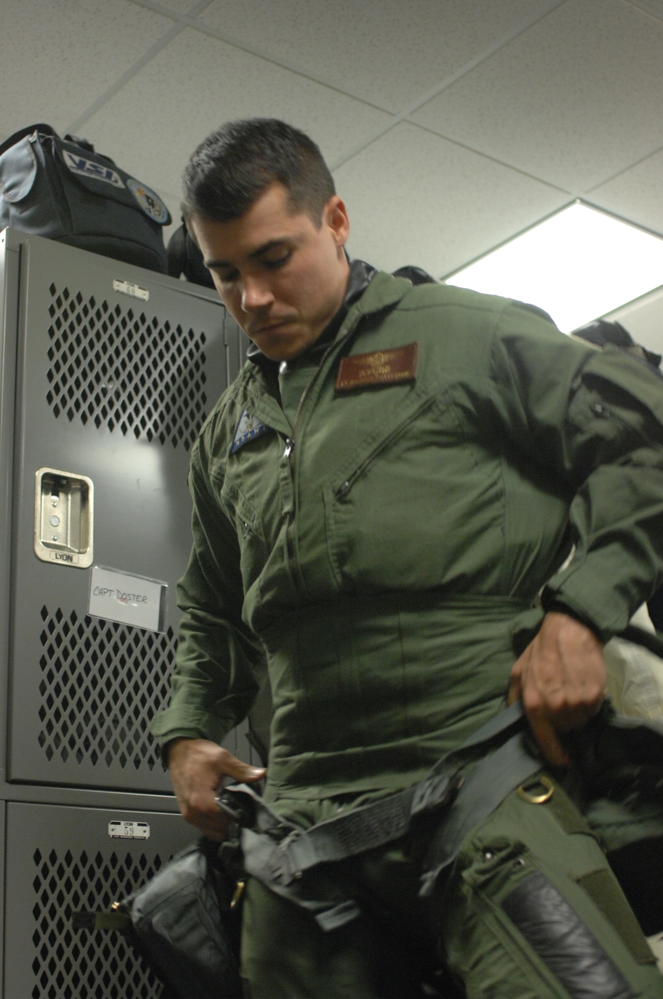 Navy Lt. Michael Patterson, a pilot with the Navy Strike Air Warfare Center, puts on his flight gear before his mission June 24 at Elmendorf Air Force Base, Alaska. (U.S. Army photo/Sgt. Ricardo Branch)