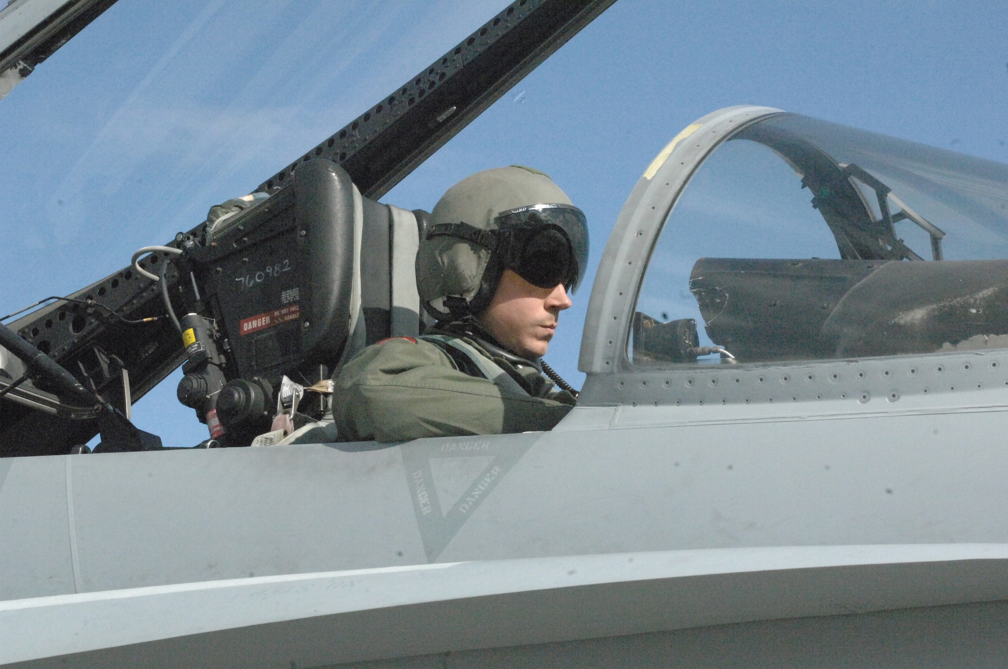 Navy Lt. Michael Patterson, a pilot with the Navy Strike Air Warfare Center, goes over preflight inspections in the cockpit of his F-18 Hornet prior to takeoff down the runway June 24 at Elmendorf Air Force Base, Alaska. (U.S. Army photo/Sgt. Ricardo Branch)