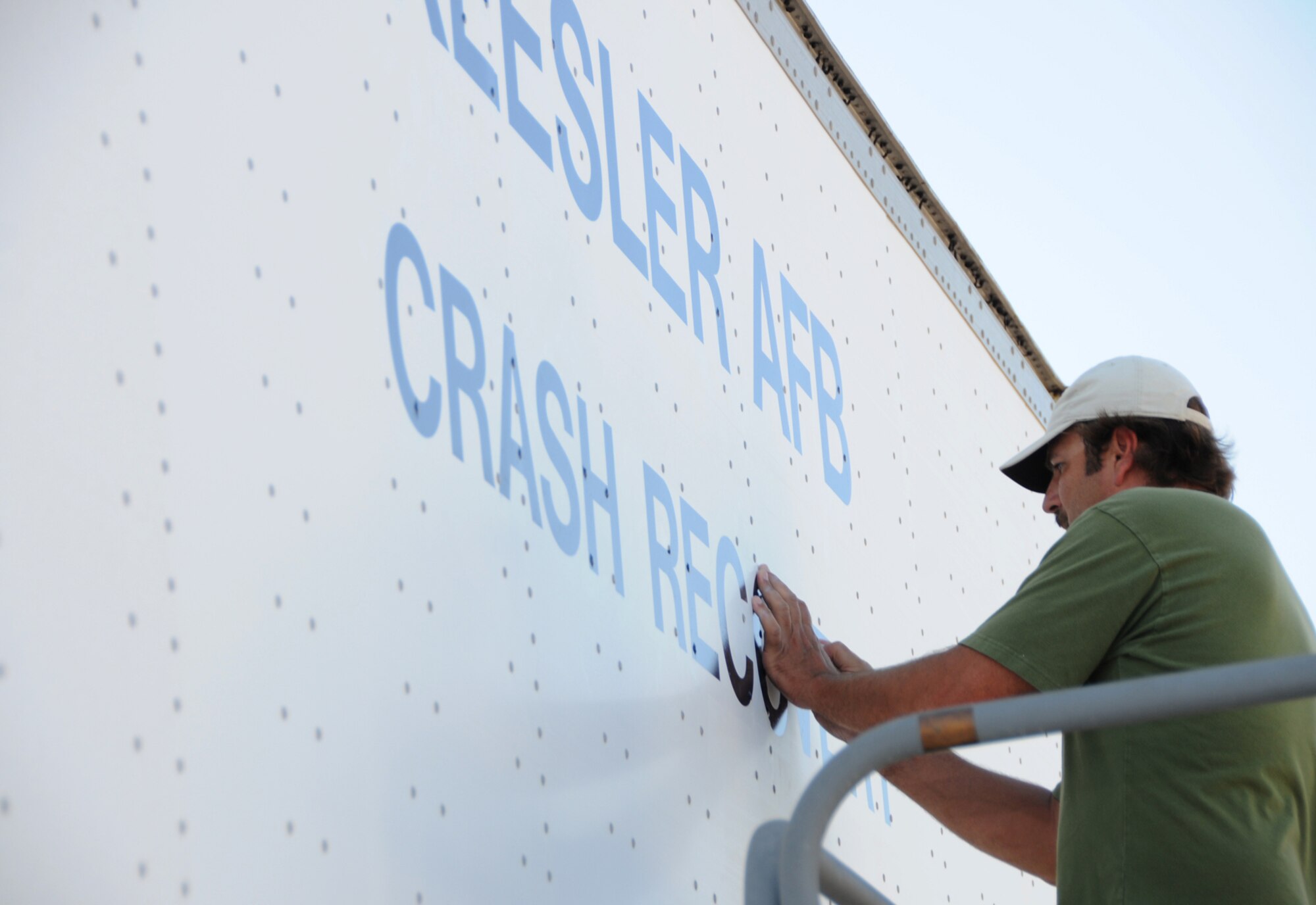 Contractor Keith Ott puts lettering on the side of the trailer to be used for the base’s crash damaged or disabled aircraft recovery program, June 18.  The 81st Operations Support Flight needed a new trailer for the CDDAR program, which applies to all Air Force host and tenant units and is designed to recover crashed or damaged aircraft.  A trailer previously used by the 85th Engineering Installation Squadron was headed to the Defense Reutilization and Marketing Office and was obtained by the 81st OSF, saving the Air Force thousands of dollars.  (U.S. Air Force photo by Kemberly Groue)