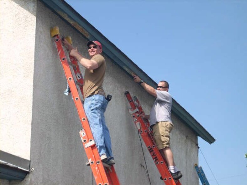 Habitat for Humanity volunteers, Master Sgt. Ted Hemmah (left) and Tech. Sgt. John Villegas, both in the 934th AW Security Forces Squadron, work on a project in the local community called A Brush with Kindness.  The project, orchestrated by Tech. Sgt. Justin D Siebenahler, 934 AW Security Forces, mobilizes community volunteers to paint, landscape and make minor repairs to homes of low-income homeowners.  (Air Force photo/Tech. Sgt. Justin D Siebenahler)