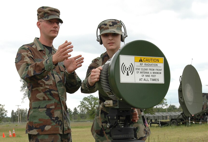 Staff Sgt. Kurt Richter Instructs Staff Sgt. Lesley Carhart,934th Communications Flight, on peak tuning of an RF modulator during Army exersise Global Medic at Fort McCoy, Wis. (Air Force Photo/Tech. Sgt. Bob Sommer)(USAF photo by Tech. Bob Sommer (RELEASED)