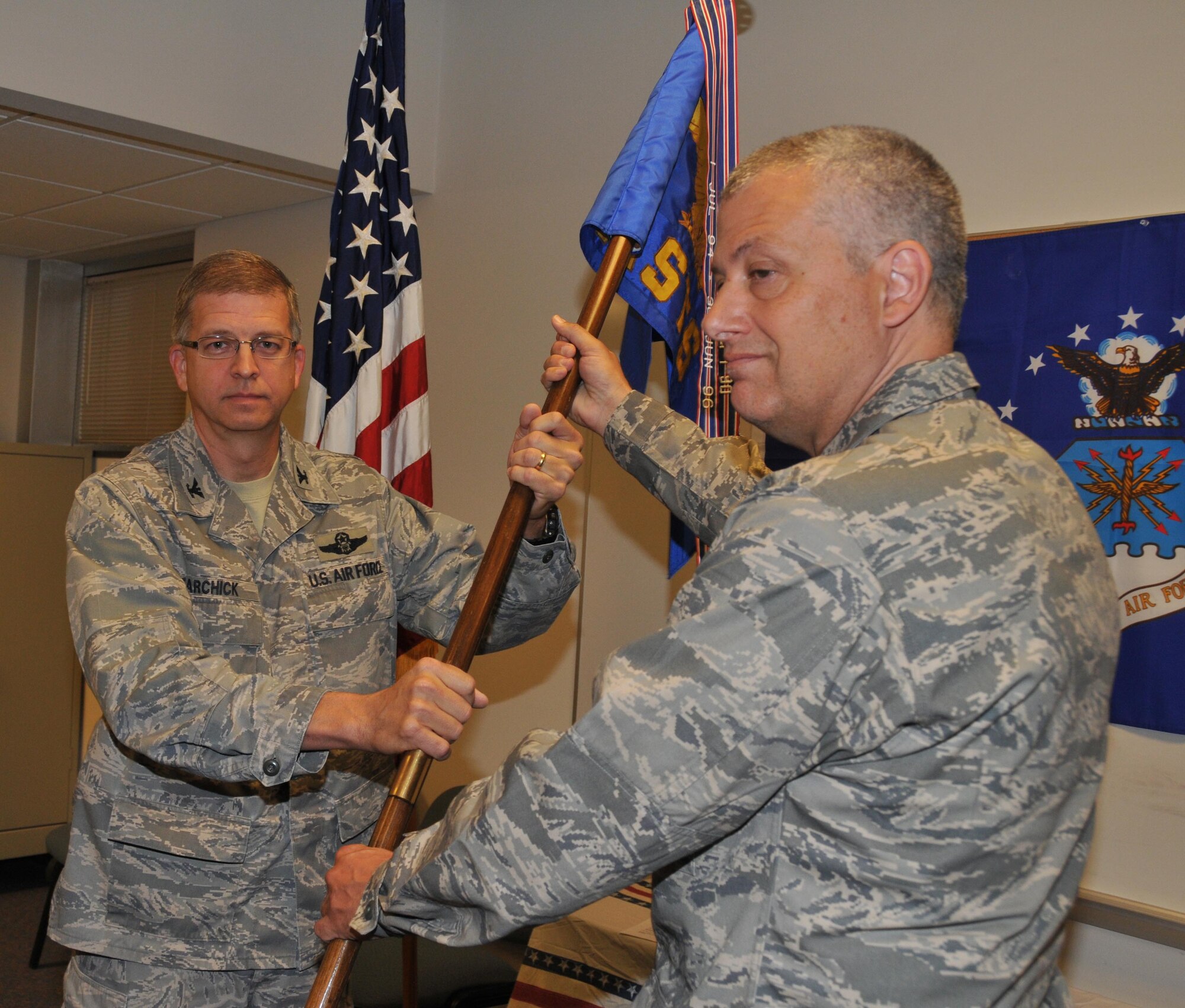Col. Philip Sweet (right) takes command of the 934th Aeromedical Staging Squadron as he accepts the squadron flag from Col. Tim Tarchick, 934th Airlift Wing commander. (Air Force Photo/Tech. Sgt. Bob Sommer)