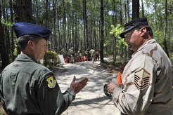 Col. John Wood talks with Master Sgt. Stephen Fraley about training requirements during his visit to the expeditionary combat skills training course June 23 at Charleston AFB. Colonel Wood is the 437th Airlift Wing commander and Sergeant Fraley is a member of the 437th Security Forces Squadron. (U.S. Air Force photo/James M. Bowman)