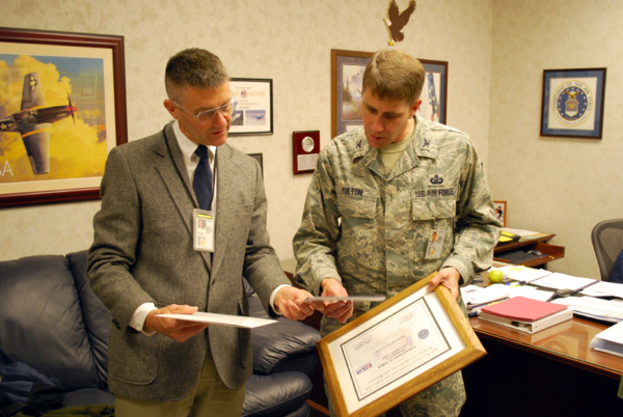 Lt. Col. Ernest M. Goodman, 507th Air Refueling Wing Civil Engineer Squadron commander, presents his civil service supervisor, Col. James G. Fulton with an Employer Support of the Guard and Reserve Patriot award. Colonel Goodman praised Colonel Fulton for supporting his Air Force Reserve career and recent 179 day AEF deployment during the presentation. 