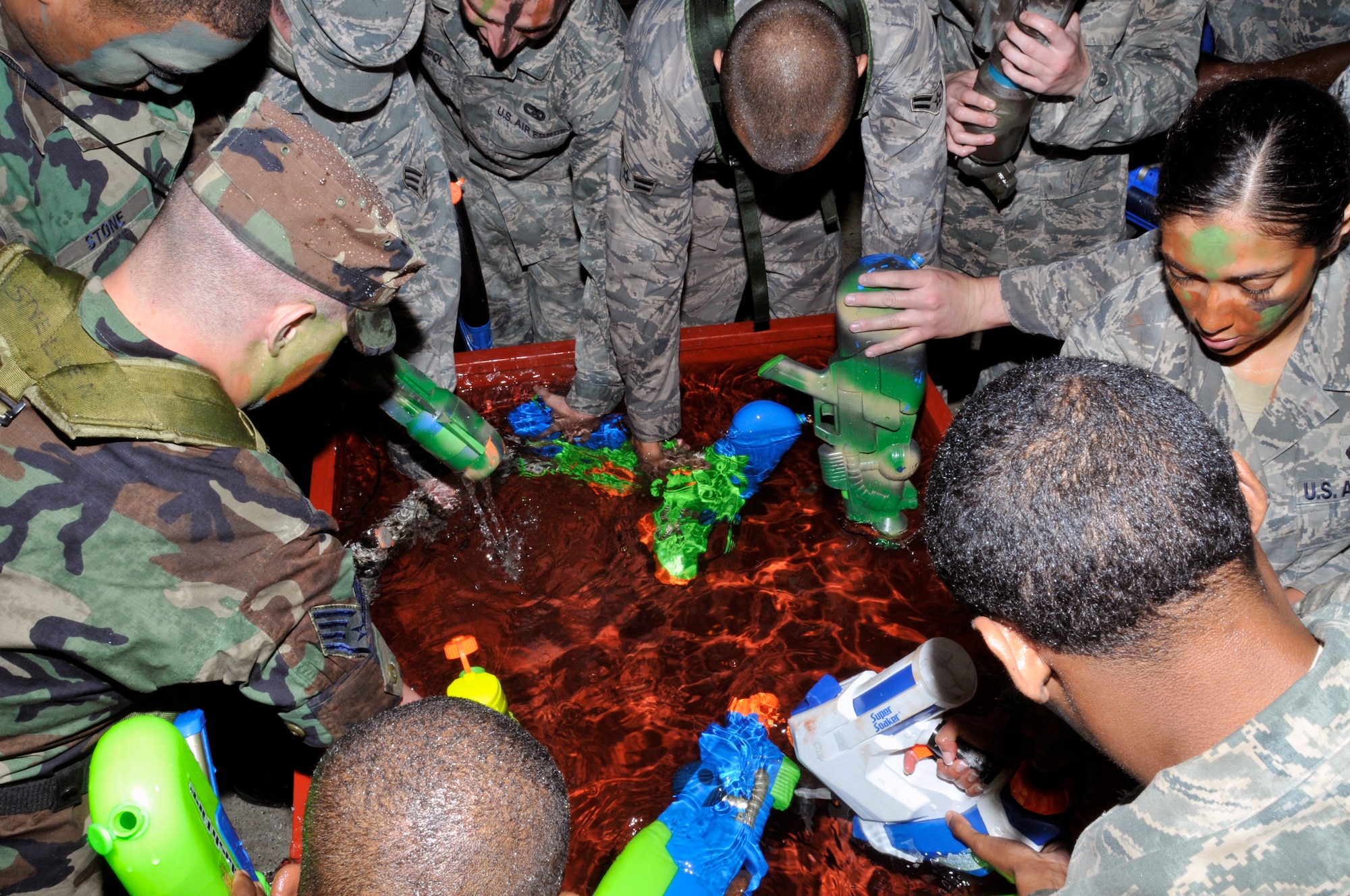 48th Fighter Wing Airmen, refill their water guns, to get back into the fight during the Liberty Wing's Combat Dining In June 19, 2009 at RAF Lakenheath, England. The event was hosted by the Liberty Wing 56. (U.S. Air Force photo by Airman 1st Class Perry Aston) (Released)