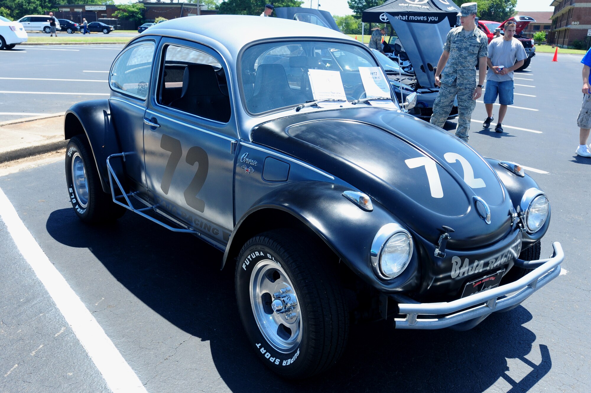 A Volkswagon bug is on display at the Car and Bike show in the Hercules Dining Facility parking lot June 19. Airmen from all across the base came together to appreciate the cars and motorcycles on display in the Hercules Dining Facility Parking lot. (U.S. Air Force photo by Senior Airman Steele Britton)