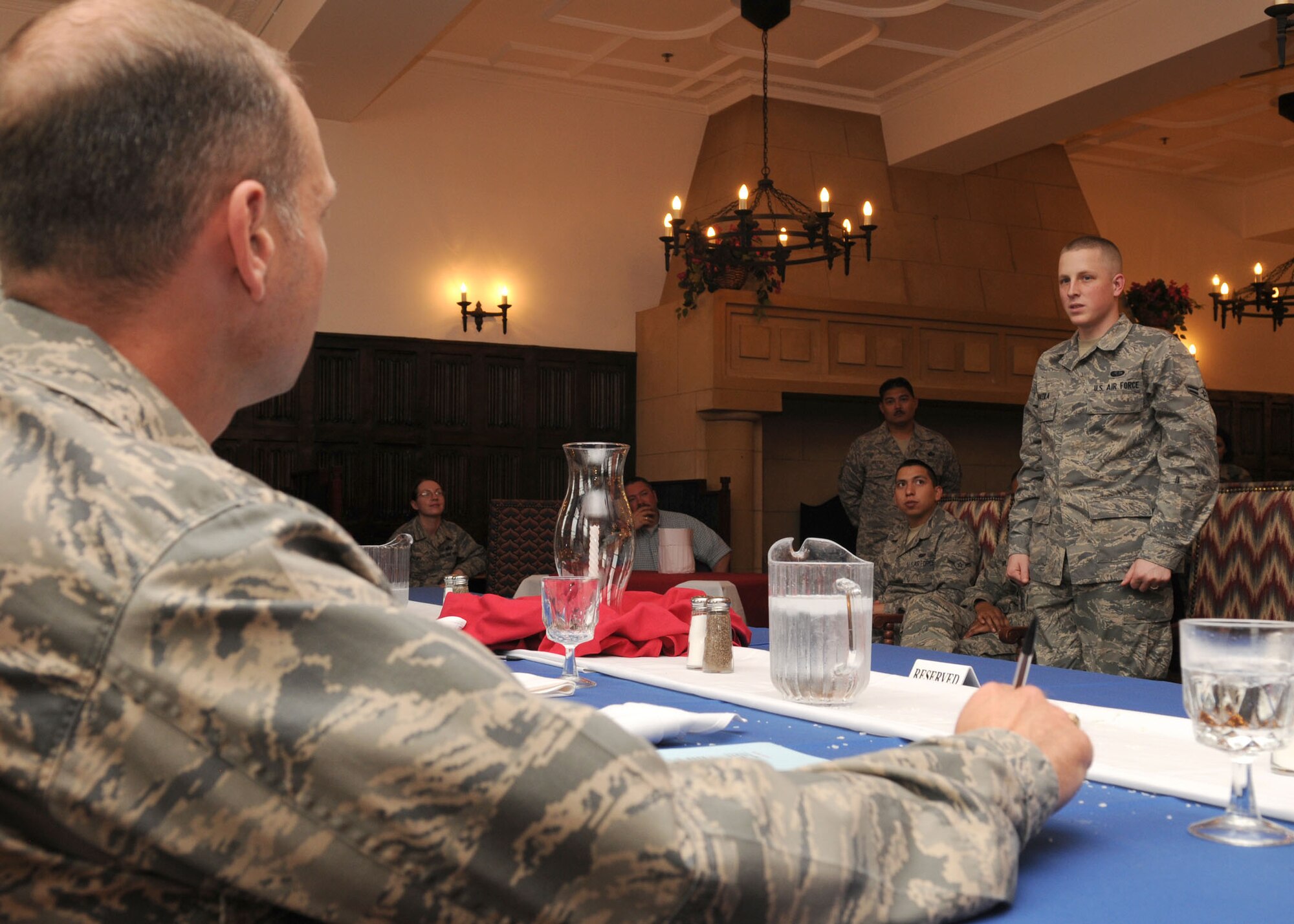 Airman 1st Class Michael Voutila is questioned about his dish by Maj. Kenneth Dewlen, 100th Force Support Squadron commander, during the judging portion of the competition on deciding who would win the Top Chef challenge June 17, 2009, at RAF Mildenhall, England. The winner received a trip to Ramstein Air Base, Germany, to compete against other base winners in United States Air Force Europe. (U.S. Air Force photo by Staff Sgt. Jerry Fleshman)