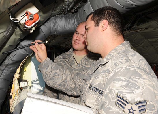 Senior Airmen Sydney Melton and John Lane, 916th Aircraft Maintenance Squadron communication and navigation specialists, inspect an emergency locator transmitter in a KC-135 Stratotanker on Seymour Johnson Air Force Base, N.C., June 24, 2009. The Airmen at the 916th are preparing their aircraft for an upcoming exercise. (U.S. Air Force photo by Airman 1st Class Gino Reyes)