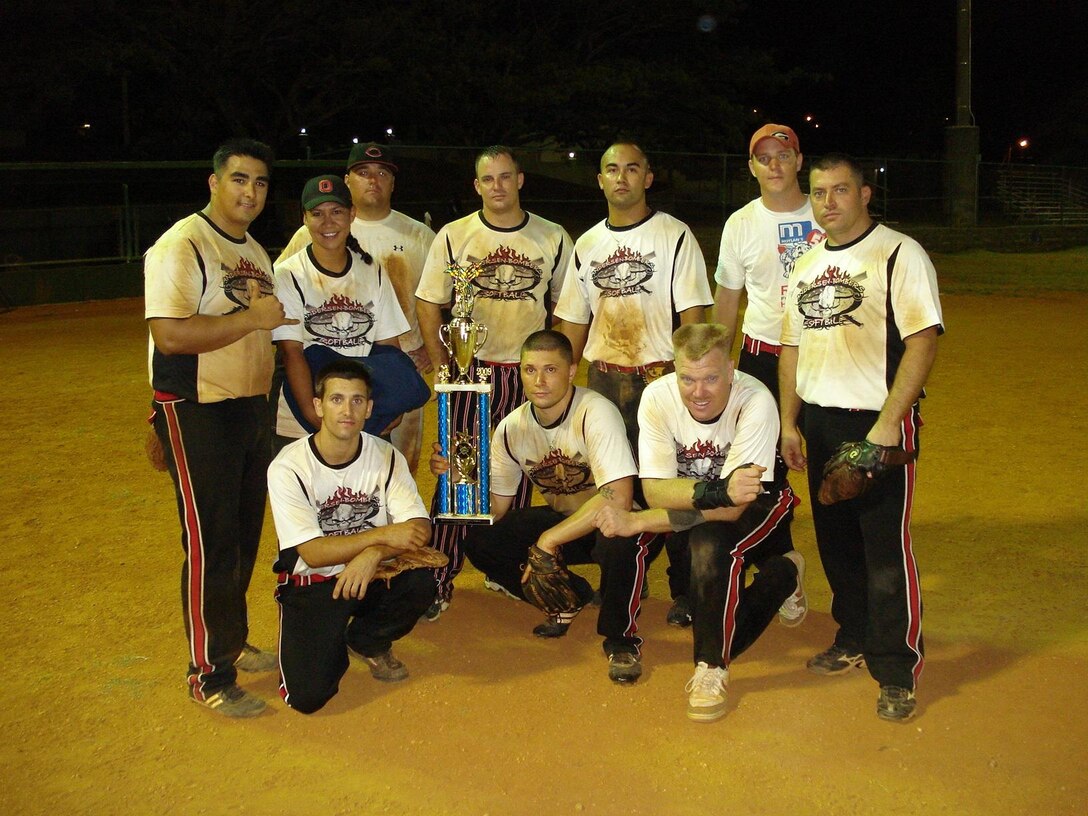ANDERSEN AIR FORCE BASE, Guam - Members of the Andersen Bombers base softball team pose with the Guam Museum Softball League championship trophy after defeating the D and Q Ballers 30-9. The Bombers bested 21 teams to earn the right to be called champions. (Courtesy photo)